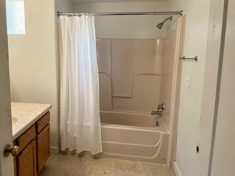 Design rendering of a dated hall bathroom with a white tub, an almond fiberglass surround and a chrome tub spout