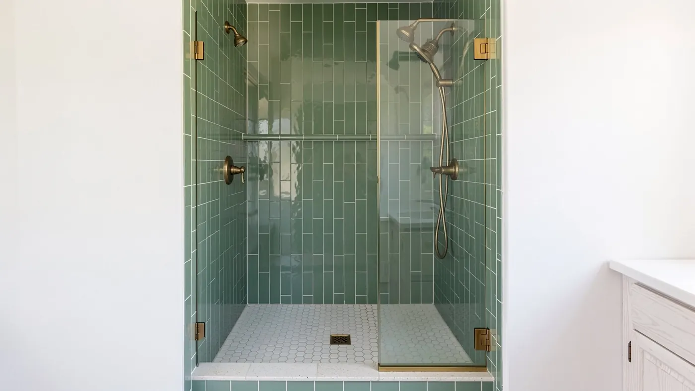 Design rendering of a walk-in shower with sage green stacked tile and brass fixtures built into a former 60 inch tub alcove